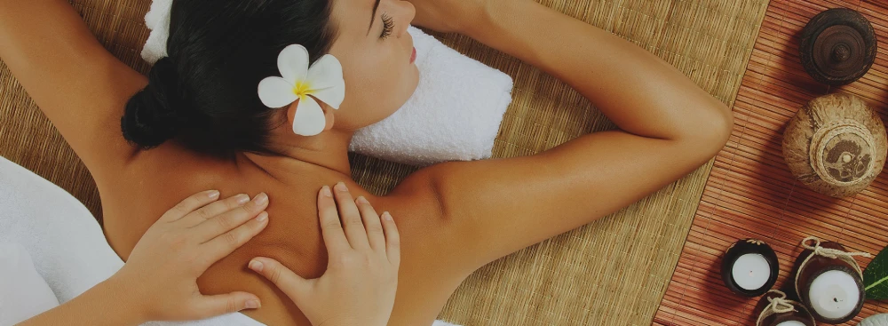 A woman receiving a massage in a serene environment